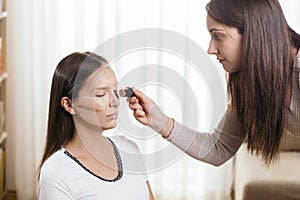 Make up artist contouring client`s face