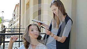 Make-up artist doing make-up for beautiful bride