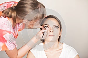 Make up artist doing makeup for model