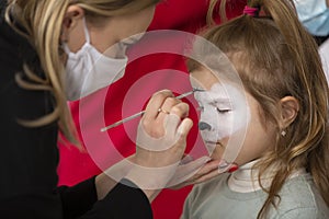 A make-up artist draws face painting photo