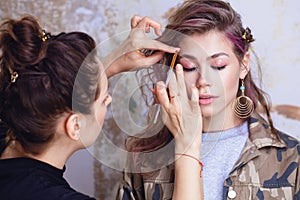 Make-up artist and model at work