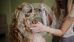 Make-up artist stiffens the bride`s hair. Professional makeup for woman with healthy young face skin-2
