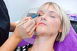 Make up artist working on model