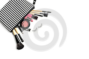 Make up bag with various cosmetics and brushes isolated