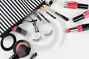 Make up bag with various cosmetics and brushes isolated