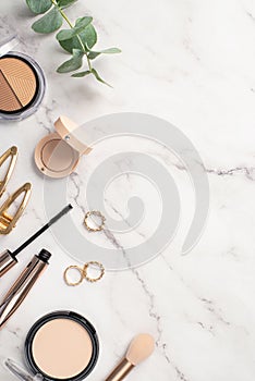 Make up beauty concept. Top view vertical photo of contouring palette compact powder makeup brush eyeshadow mascara gold rings