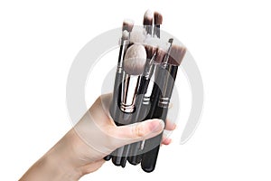 Make-up brush cosmetic in female hand beautician is