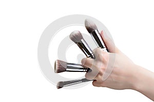 make-up brush cosmetic in female hand beautician is