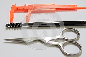 Make-up brush, pachymeter ans scissors isolated on white background