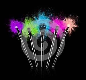 Make up brushes with colourful powder splashes on black