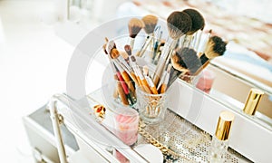 Make-up brushes and cosmetic on dressing table