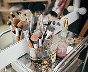 Make-up brushes and cosmetic on dressing table