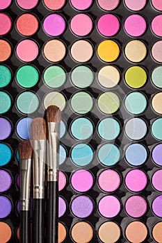 Make-up brushes on eyeshadow make-up palette with copyspace