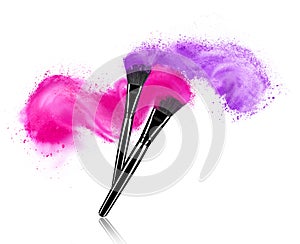 Make up brushes with powder splashes isolated on white