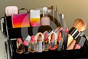 Make up case containing colorful eyeshadows, lipsticks, lip glosses, blushes and nail polishes