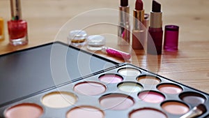 Make-up colorful cosmetic palette, lipstick, brushes and nail laquer bottles