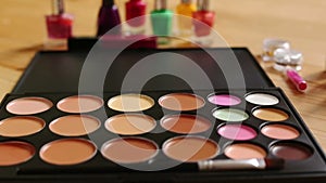 Make-up colorful cosmetic palette, lipstick, brushes and nail laquer bottles