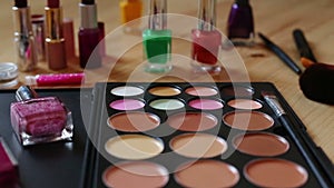 Make-up colorful cosmetic palette, lipstick, brushes and nail laquer bottles