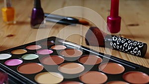 Make-up colorful cosmetic palette, lipstick, brushes and nail laquer bottles