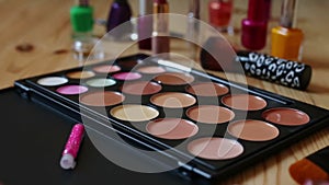 Make-up colorful cosmetic palette, lipstick, brushes and nail laquer bottles