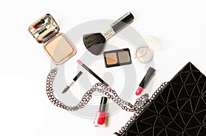 Make up cosmetic bag with professional accessories. Lipsticks and brushes in a black cosmetic bag in white background