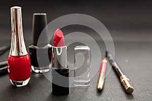 Make-up cosmetics accessories against black background