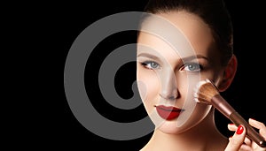 Make-up and cosmetics. Beauty woman face isolated on black backg