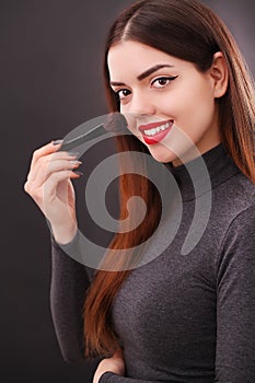 Make-up and cosmetics concept. Asian woman doing her makeup eyelashes dark mascara.