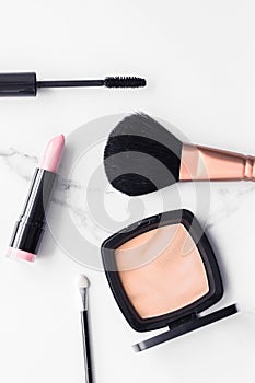 Make-up and cosmetics flatlay on marble