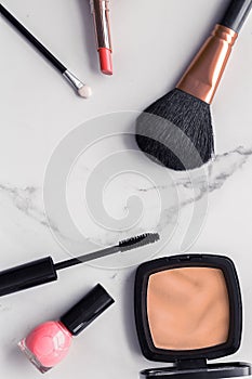 Make-up and cosmetics flatlay on marble