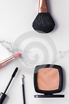 Make-up and cosmetics flatlay on marble
