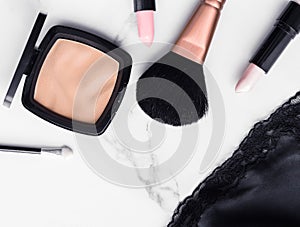 Make-up and cosmetics flatlay on marble