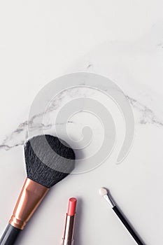 Make-up and cosmetics flatlay on marble