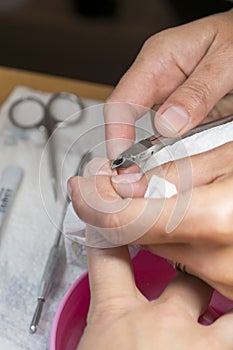 make-up facilities. Closeup of manicure applying, cutting the cuticle with scissors. Manicure process in beauty salon, close up. v