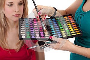 Make-up girl showing range of collors photo