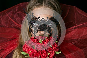 Make-up girl witch on halloween costume in black mask.