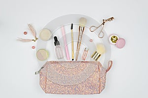 Make up glossy bag and set of professional decorative cosmetics, makeup tools and accessory on white background. beauty