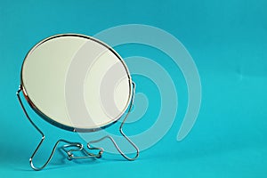 Make up mirror, blue background, free copy space, selective focus