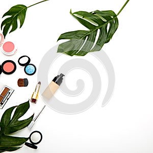 Make up products and brushes on white