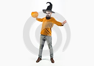 Make up and scary concept for man - full length. Halloween concept. Young man with witch hat dressed as vampire for