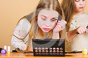 Make up school. Makeup art. Explore moms cosmetics bag concept. Salon and beauty treatment. Children little girls make