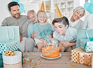 Make a wish. Cropped shot of a happy family celebrating a birthday together at home.