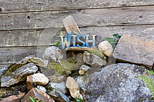 Make a wish sign mounted on top of rocks