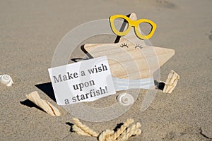 MAKE A WISH UPON A STARFISH text on paper greeting card on background of funny starfish in glasses summer vacation decor