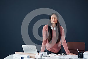 Make it your business to succeed. Portrait of an attractive young female architect working in her office.