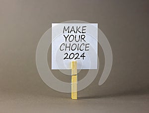 Make your choice 2024 symbol. Concept words Make your choice 2024 on beautiful white paper on clothespin. Beautiful grey