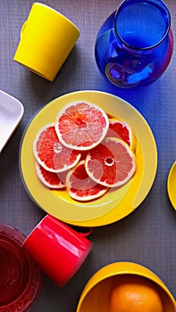 Make Your day Bright Colorful dishes red cup blue vase yellow plate yellow cup on pink background still life background illu