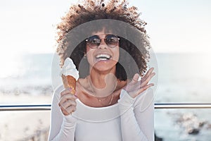 Make your inner child happy. a young woman enjoying an ice cream cone outdoors.