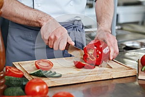 Make it your mission for good nutrition. Chef preparing dish in commercial kitchen. Close up