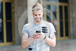 Make your own blog. Handsome man typing new blog post from smartphone. Blogger keeping private blog on the go. Modern